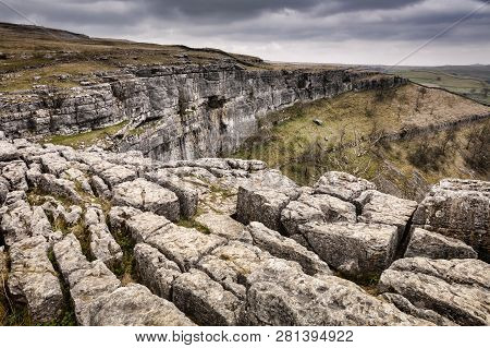Limestone Karst At Malham Cove, Yorkshire Dales, North Yorkshire, England, With Overcast Sky And Fla