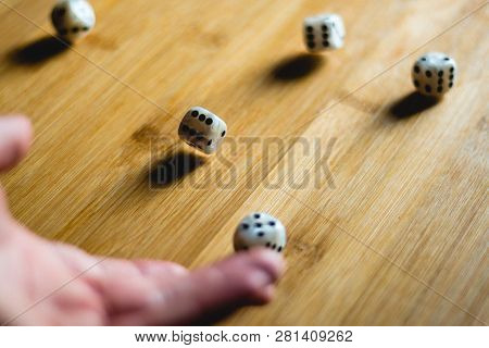 Dices Bouncing On A Wooden Table. Single Or Group