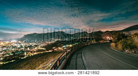 Terracina, Italy. Top View Skyline Cityscape City In Evening Night Illuminations. Night Open Road An