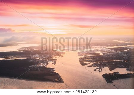 Latvia, Europe. Aerial View Of Western Dvina Flows Into Baltic Sea Near Riga During Winter Sunrise. 