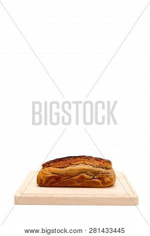 A Homemade Plumcake Standing On A Wooden Board With A White Background