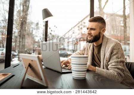 Attentive Serious Self-employed Man Spending Time In Well-furnished Cabinet