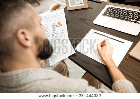 Responsible Well-organized Man Filling Up Calendar With Affairs