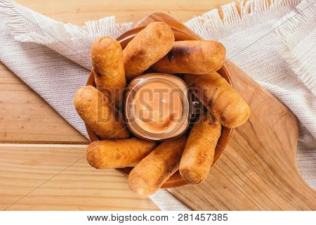 Top View Of Latin-american Appetizers Called Tequeños Made Of Fried Corn Filled With Cheese With A P