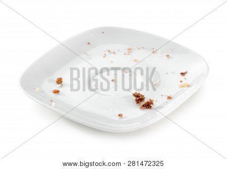 Porcelain Plate With Crumbs Close-up Isolated On White Background