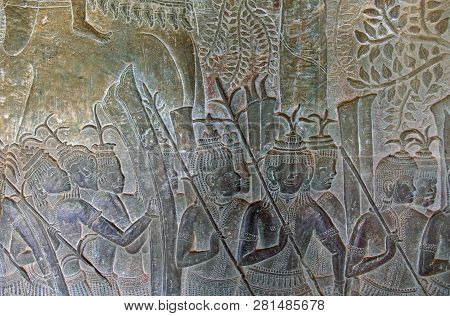 Bas-relief In Ancient Temple Angkor Wat, Siem Reap, Cambodia. Military Scene On Stone Wall. Ancient 