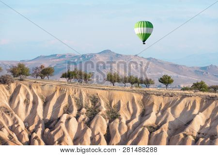 Green balloon in the sunrise sky. Cappadocia, Turkey. Landscape photography
