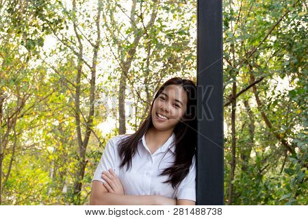 Young Collage Woman Smiling With Arms Folded With Nauter Sunlight.