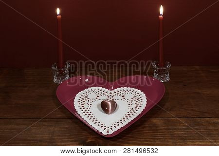 Pink Heart Shapped Plate With Dollie And Gemstone, Two Red Candles In Crystal Holoders On Wooden Tab
