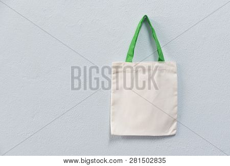 White Tote Canvas Fabric Eco Bag Cloth Shopping Sack On Wall Background / Zero Waste Use Less Plasti