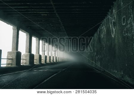 On A Foggy Road Along Nature With A Limited View. Rood In Fog.