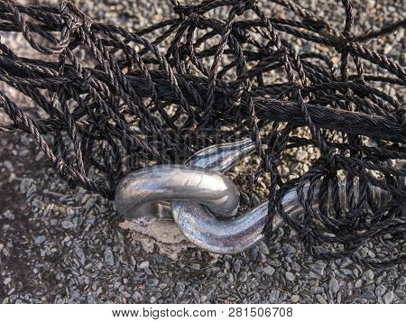 Steel Turnbuckle And Steel  Sling Anchored Safety Net Into Concrete Block.