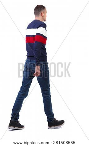 Back view of going  handsome man in sweater. walking young guy . Rear view people collection. Isolated over white background. A tall, slender man in jeans and a striped sweater is slowly moving forwar