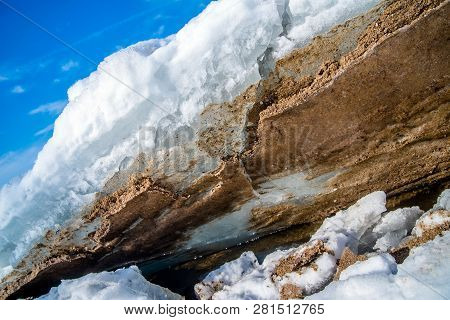 Blocks Of Ice Melt In The Spring On The Shore Of The Pond