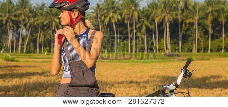 Cyclist Woman Putting Bike Helmet On - Head Protection On Outdoor Sport Activiy. Girl On Bicycle Dur