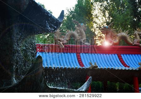 Chinese Dragons, Statues Of Ronin And Fountains At Sunset