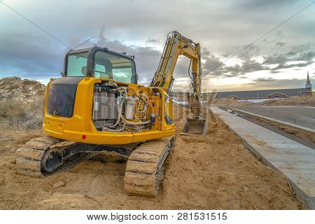 Excavator With Utah Valley Church In Background