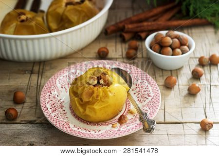Baked Apples With Raisins, Hazelnuts And Cinnamon On Wooden Background. Rustic Style.