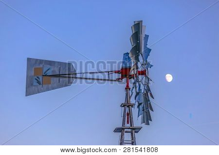 Windpump With Multiple Blades Against Sky And Moon