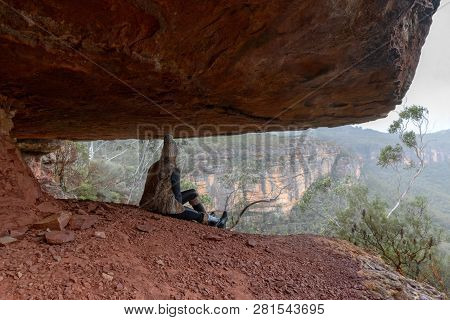 Sitting In The Undercliff Ledge With Views Of The Blue Mountains Escarpment And Valleys