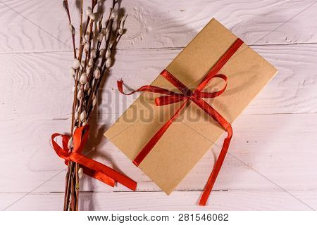 Pussywillow Bouquet And Cardboard Gift Box On White Wooden Table. Top View
