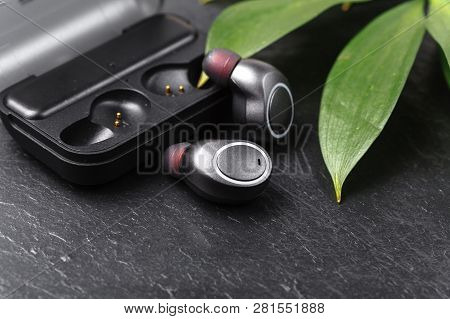 Wireless Earphones Close Up View On Black Stone