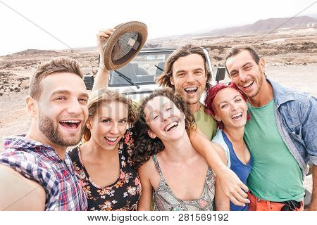 Group Of Travel Friends Taking Selfie In The Desert During A Roadtrip  - Happy Young People Having F