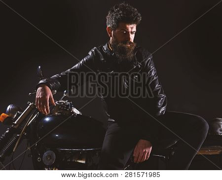 Macho, Brutal Biker In Leather Jacket Stand Near Motorcycle At Night Time. Brutality And Masculine C