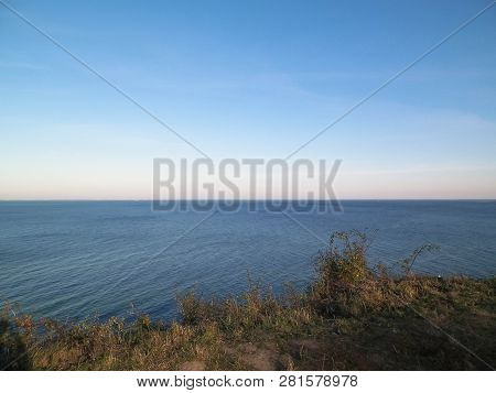 Baltic Sea From Cliff In Mechelinki, Poland. Nature And Travel Concept. Copy Space On Blue Sky.