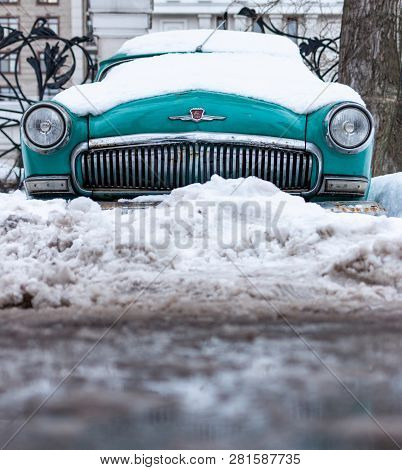 Old Soviet Car Volga. Turquoise Retro Car Covered With Snow. Gaz-21 On The Street In Winter.