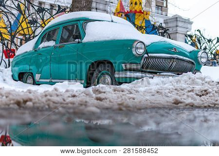 Old Soviet Car Volga. Turquoise Retro Car Covered With Snow. Gaz-21 On The Street In Winter.