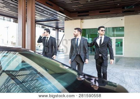 Dedicated Security Agents Examining Surrounding While Walking With Famous Personality Towards Car