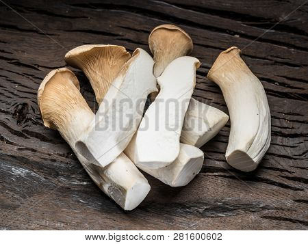 King oyster mushrooms on the wooden background.