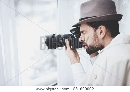 Private Detective Agency. Man In Hat Is Taking Photos In Window.
