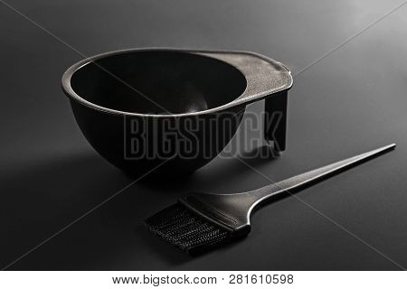 Hair Coloring Tools: Black Brush And Bowl On A Black Background
