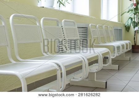 Seat Waiting For The Doctor In The Hospital.empty And Clean Waiting Area With Metallic Chairs In Cli
