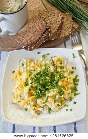 Tasty Breakfast. Scrambled Eggs Decorated With With Fresh Chopped Chive. Slices Of Dark Bread, Chive