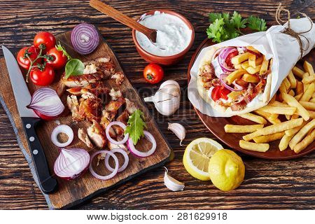 Overhead View Of Greek Souvlaki, Pita Ma Gyros With Chicken Meat, Vegetables, French Fries And Yogur