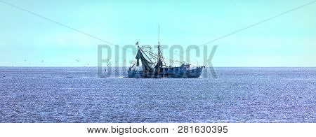 A Shrimp Boat On Sunny Sea Surrounded By Birds
