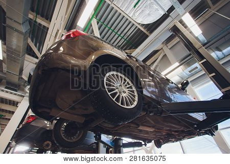 Car Raised On Car Lift In Autoservice.