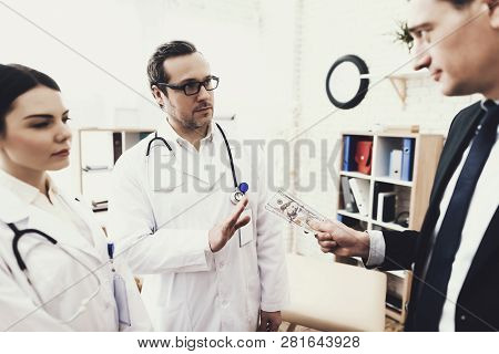 Doctor With Stethoscope Refuses To Take Money From Patient. Concept Of Corruption In Medicine. Bribe