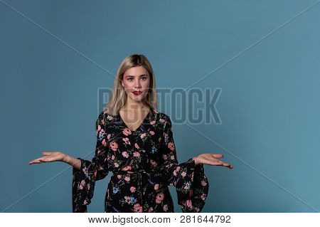 Blonde Young Woman In Spring Dress Showing Open Palm With Copy Space For Prodact