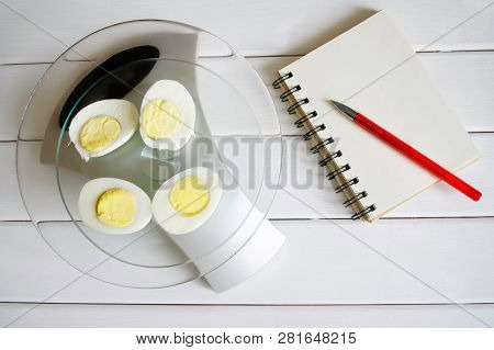 Counting The Amount Of Protein, Calories, Carbohydrates And Fats In Food. Chicken Egg On The Kitchen