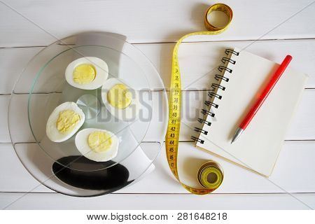 Counting The Amount Of Proteins, Carbohydrates, Fats And Calories In Food. Chicken Egg On The Kitche