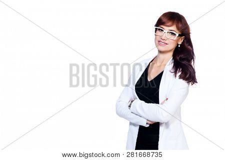 A portrait of a beautiful woman wearing classic clothes and posing over the white background in the studio. Beauty, fashion, business.