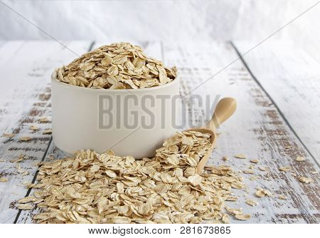 Dried Oats Or Oatmeal In A Bowl On The Wood Table. Its Are A Nutrient-rich Food Associated With Prot