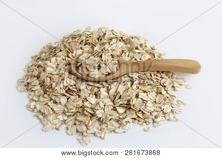Dried Oats Or Oatmeal In Spoon On The Wood Table. Its Are A Nutrient-rich Food Associated With Prote