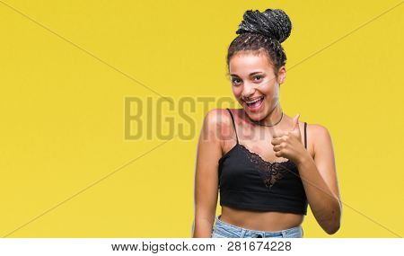 Young braided hair african american with pigmentation blemish birth mark over isolated background doing happy thumbs up gesture with hand. Approving expression looking at the camera