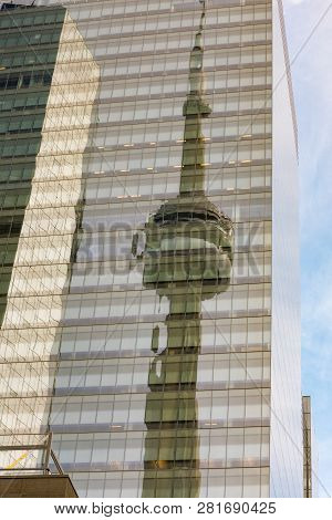 Toronto, Ca, Dec 16, 2017: Communications And Observation Cn Tower Reflected In Glass Facade Of High