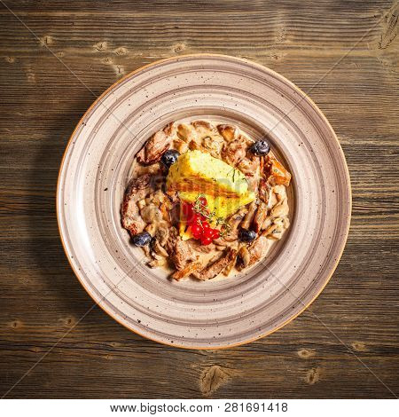 Flat Lay Of Beef Tenderloin Stew With Roasted Polenta On Wooden Background